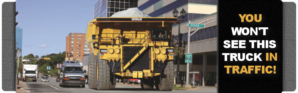 large dump truck in the middle of a city street